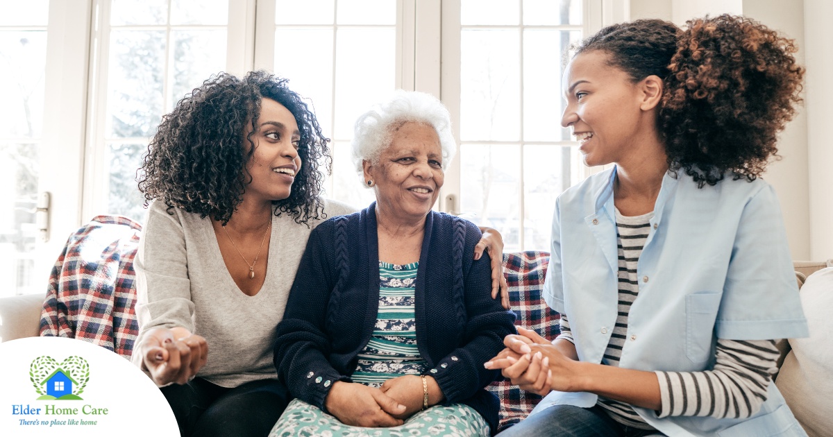 A caregiver talks with a client and her daughter, representing the type of communication that is vital when taking on a person-centered care approach.